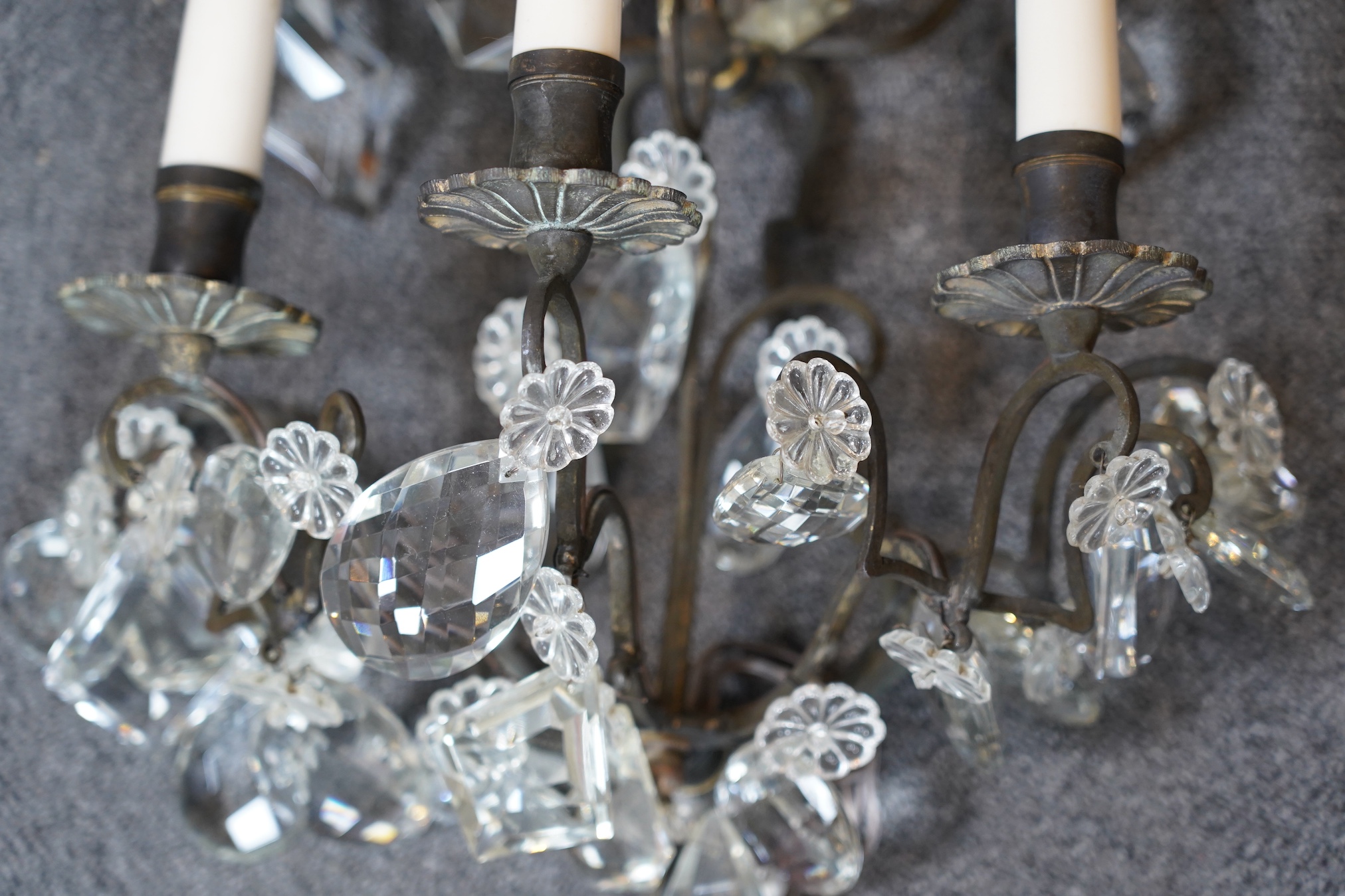 A two tier chandelier with eight branches on each tier, together with a pair of three branch wall lights, chandelier approximately 73cm high